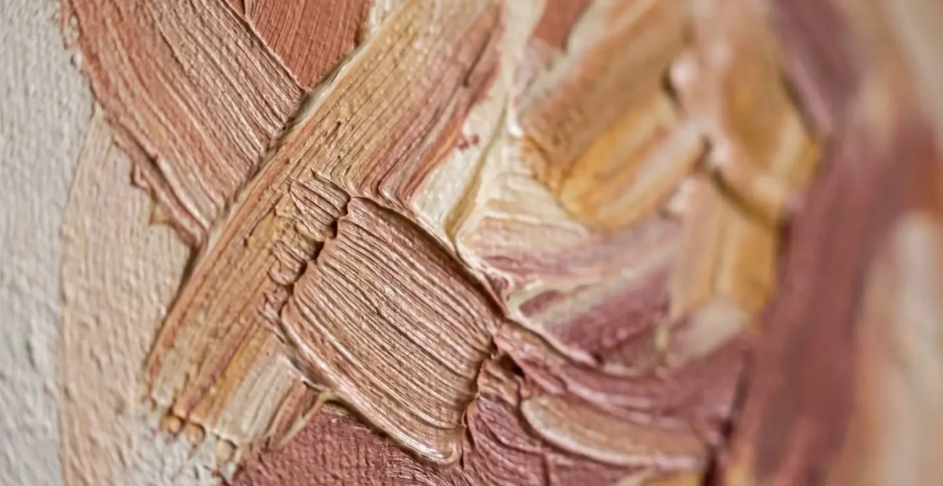 Extreme macro close-up of hand-painted mural brushstrokes showing tactile paint texture and layering