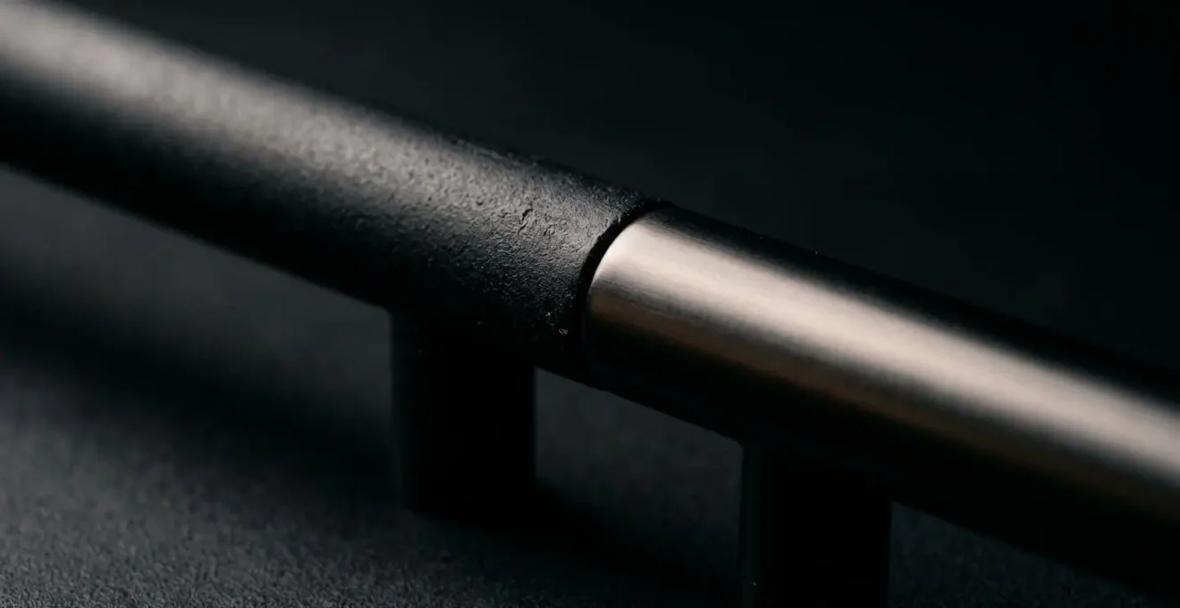 Close-up detail of matte and satin black metal finishes showing light interaction and texture differences