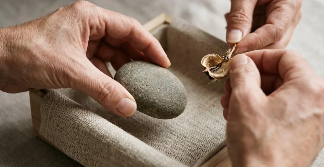 Close-up of hands organizing seasonal decor items using the one-in-one-out method with neutral storage solutions