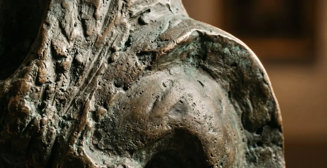 Close-up macro photograph showing dramatic lighting effects on textured sculptural surface demonstrating museum-quality illumination
