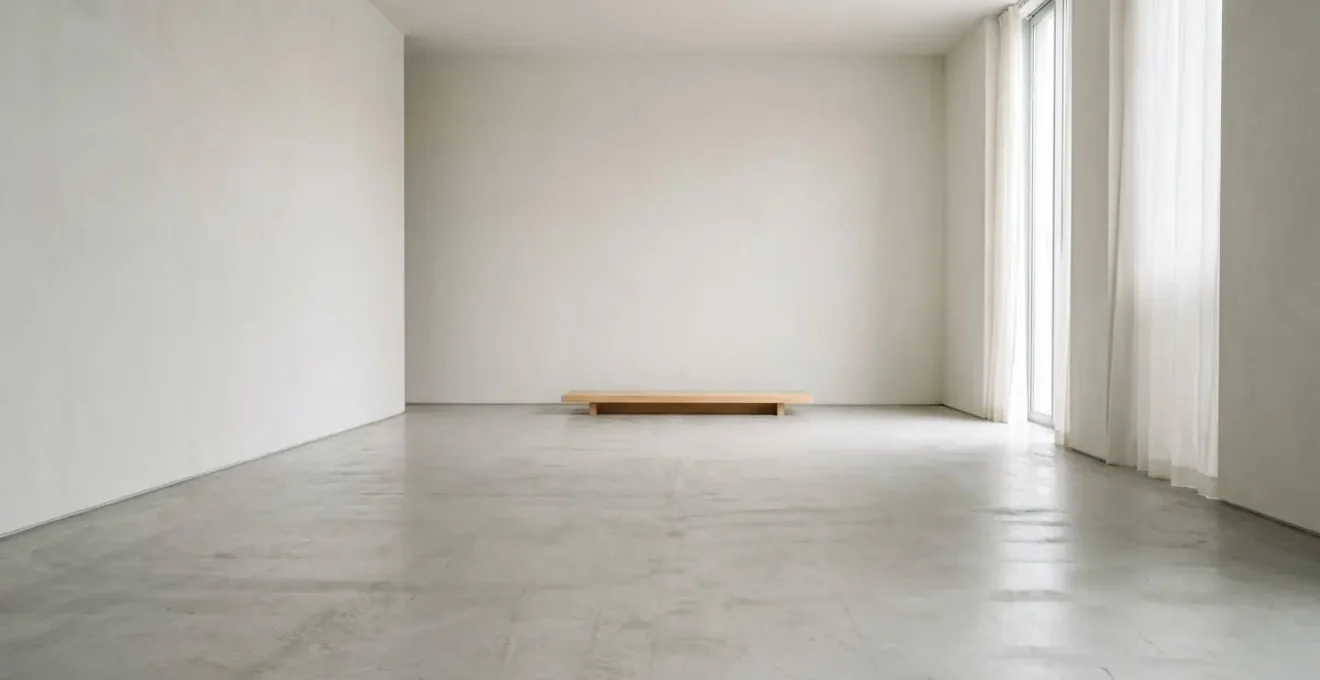 Wide-angle minimalist interior showcasing Japanese Ma concept with intentional empty space and subtle natural elements