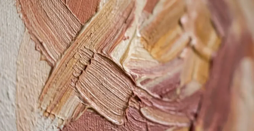 Extreme macro close-up of hand-painted mural brushstrokes showing tactile paint texture and layering